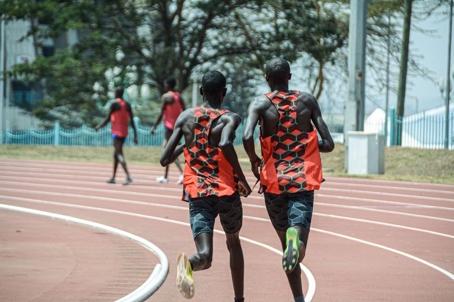 Two runners training on a track in Kenya