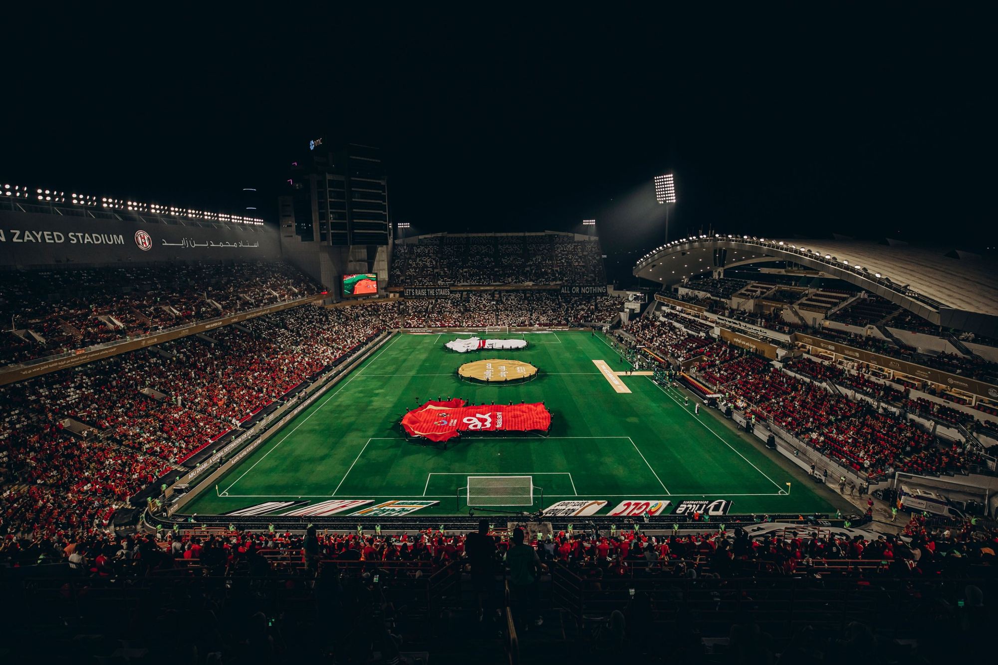 A full football stadium at night before kick-off